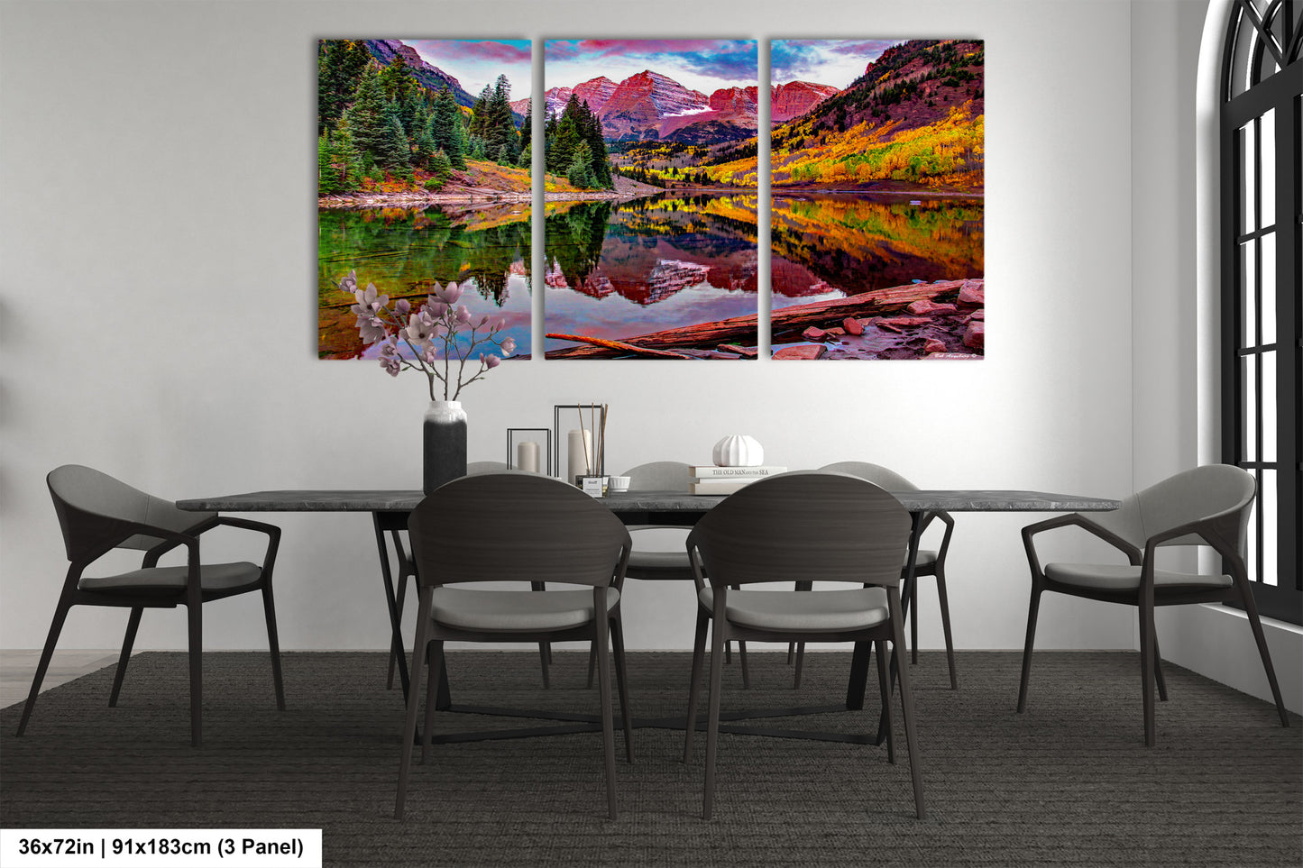 a dining room table with chairs and a painting on the wall
