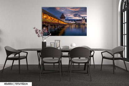 a dining room table with chairs and a painting on the wall