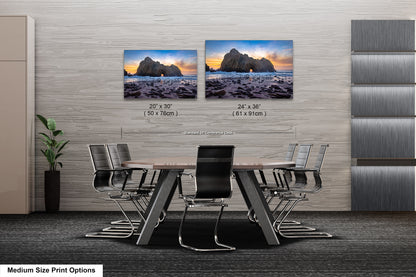 a dining room table with chairs and two pictures on the wall