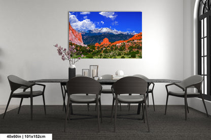 a dining room table with chairs and a painting on the wall