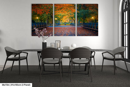 a dining room table with four chairs and a painting on the wall