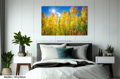 a bed room with a neatly made bed and a painting on the wall