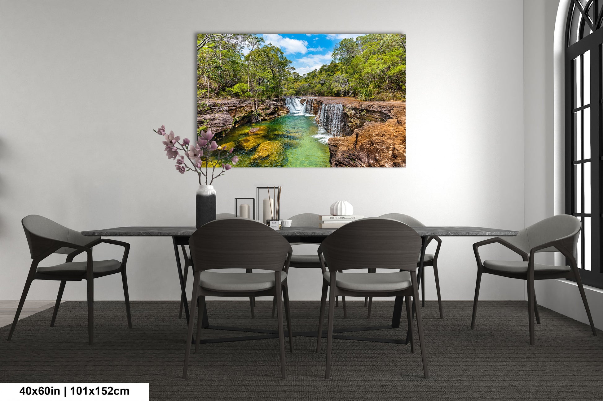 a dining room table with chairs and a painting on the wall