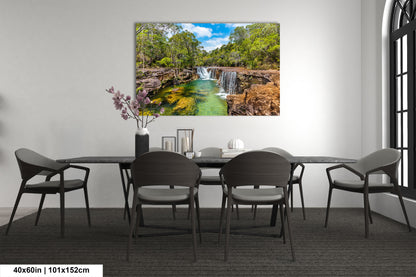 a dining room table with chairs and a painting on the wall