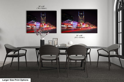 a dining room table with four chairs and a vase of flowers