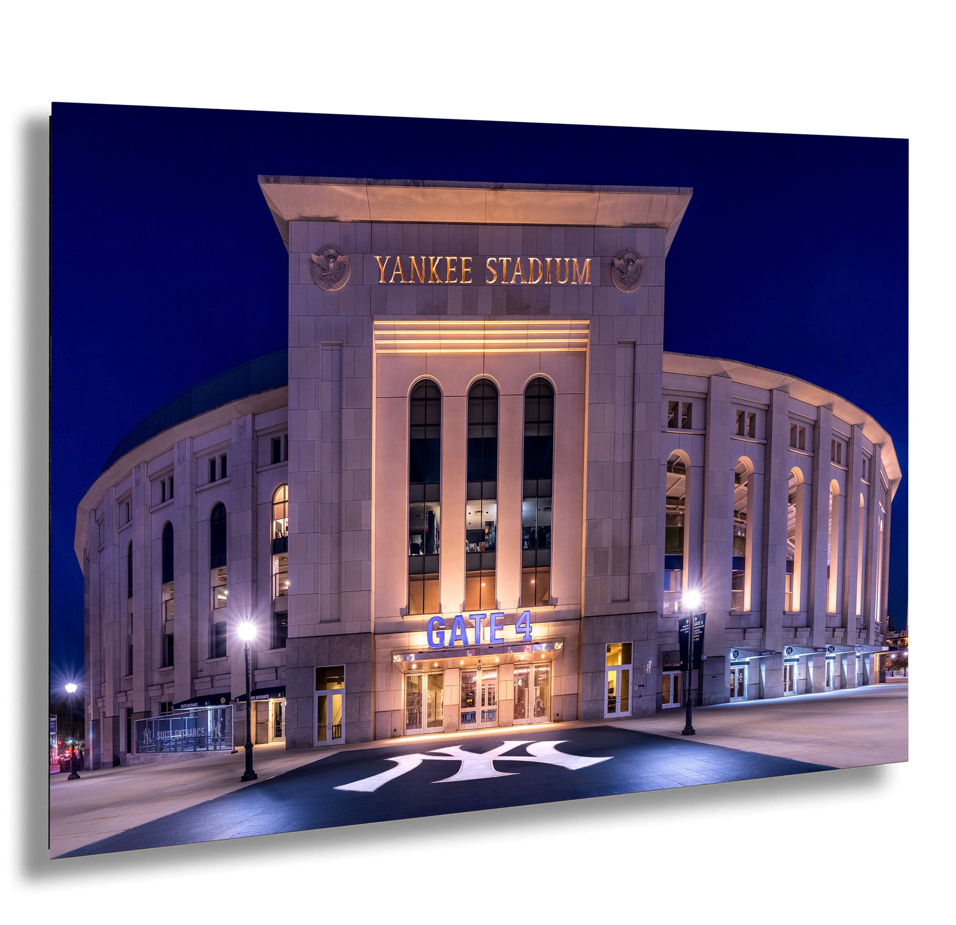 the Yankee Stadium, a large stadium located in New York City, illuminated at night.