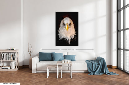 a living room with a white couch and a painting of an eagle