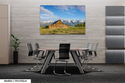 a dining room table with chairs and a picture of a barn on the wall