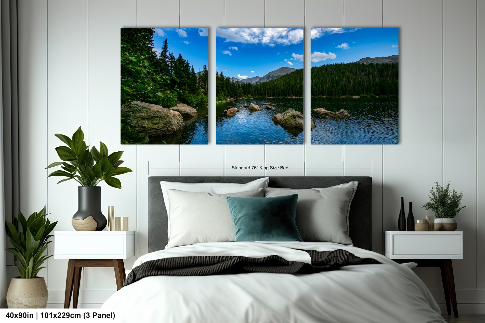 The image is a bedroom with a large, three-panel landscape painting hanging on the wall above the bed. The painting depicts a serene scene of a lake surrounded by trees and mountains.