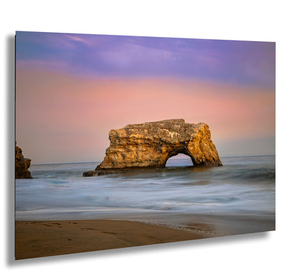 a large rock sticking out of the ocean