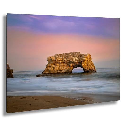 a large rock sticking out of the ocean
