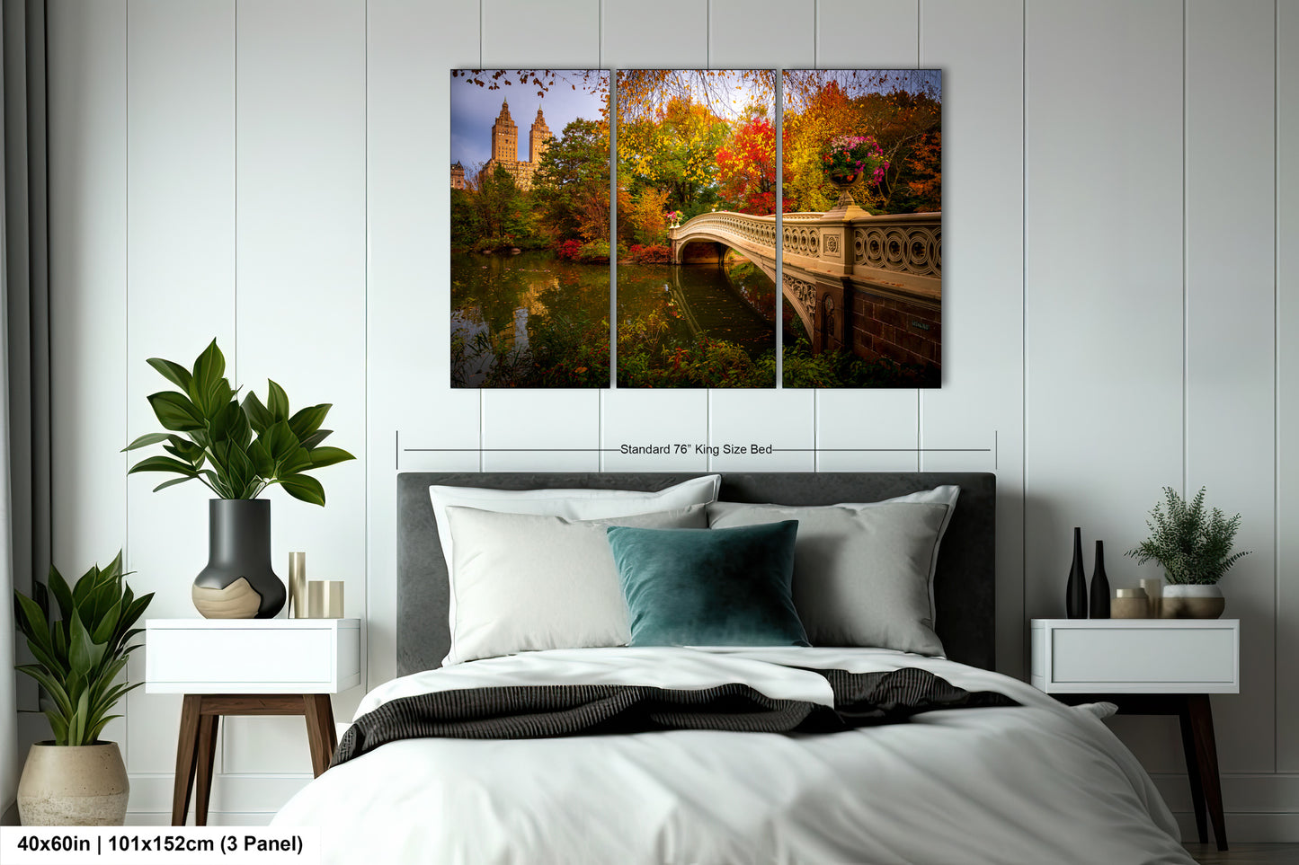The image is a bedroom with a large bed, nightstands, and a painting of a bridge and trees hanging on the wall.
