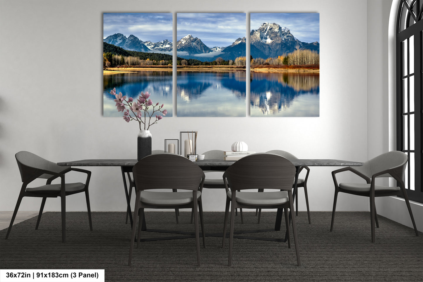 a modern dining room with a large, three-panel landscape painting of a mountain lake hanging on the wall above a black dining table surrounded by chairs.