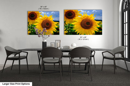 a dining room table with four chairs and two large sunflowers on the wall