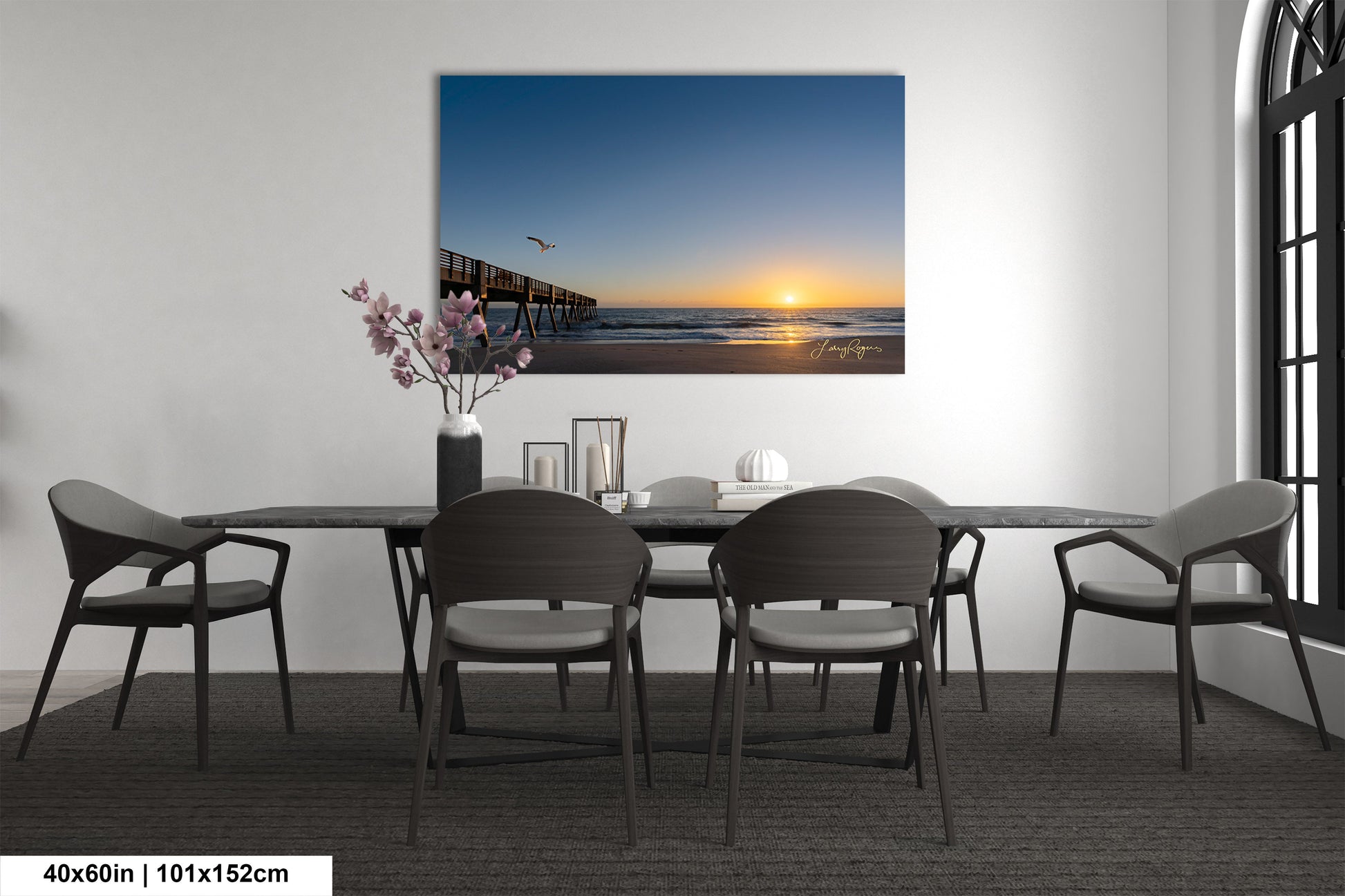 a room with a table and chairs and a painting on the wall