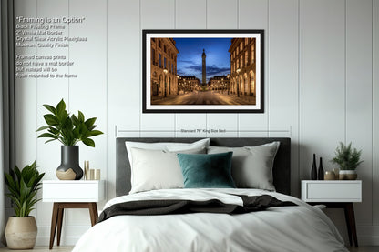 a bedroom with a bed and a picture hanging on the wall