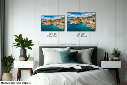 a bedroom with a bed and two pictures on the wall