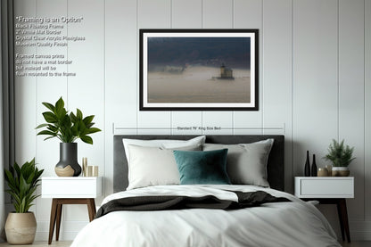 a bedroom with a bed and a picture hanging on the wall