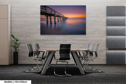 a dining room table with chairs and a painting on the wall