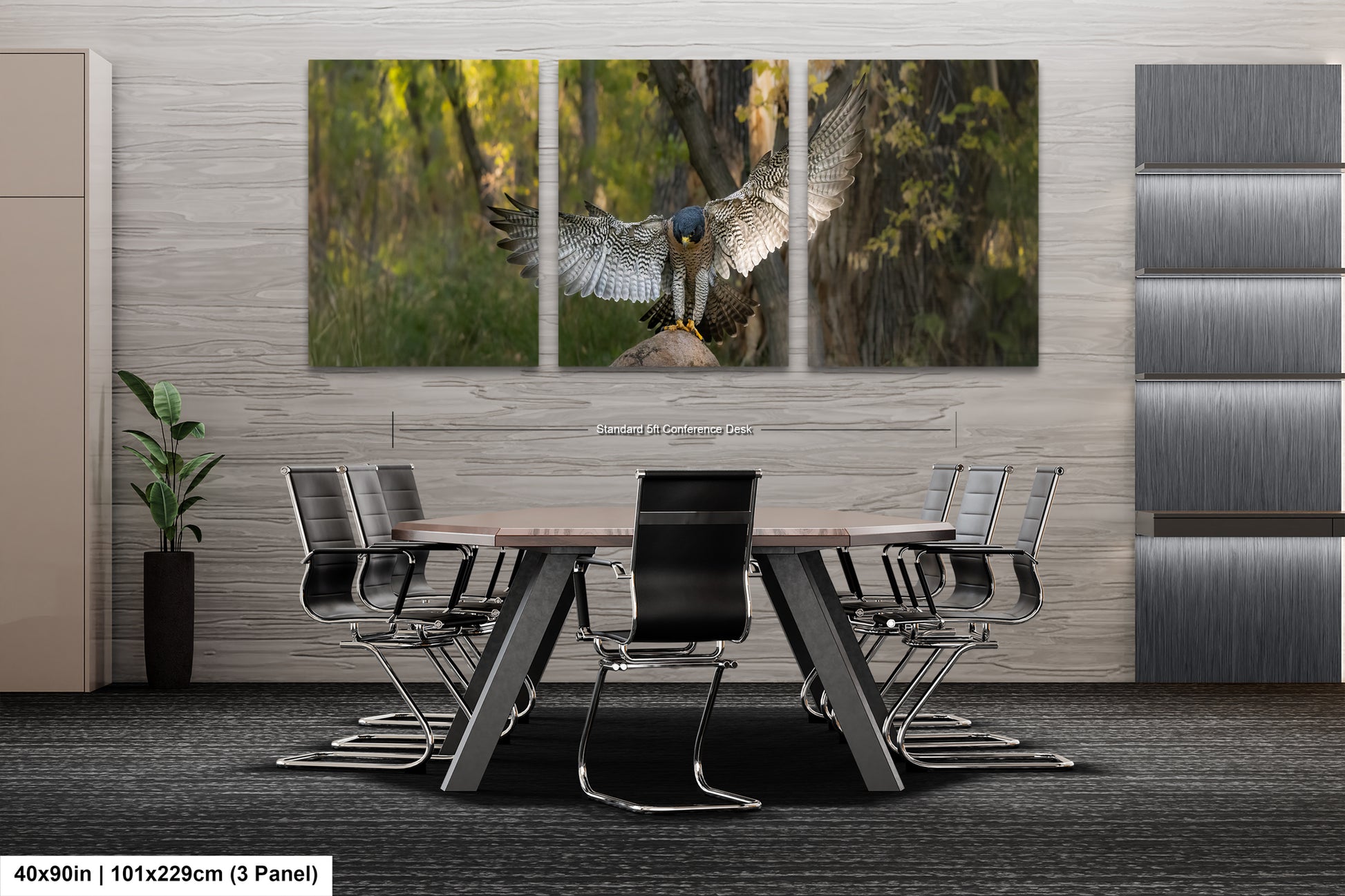 A modern office space with a large, three-panel artwork depicting a bird of prey in flight. The artwork is mounted on a gray wall above a wooden table surrounded by black chairs.