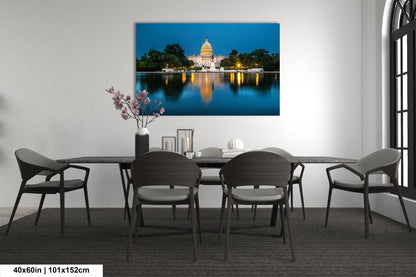 a dining room table with chairs and a picture of the capitol building