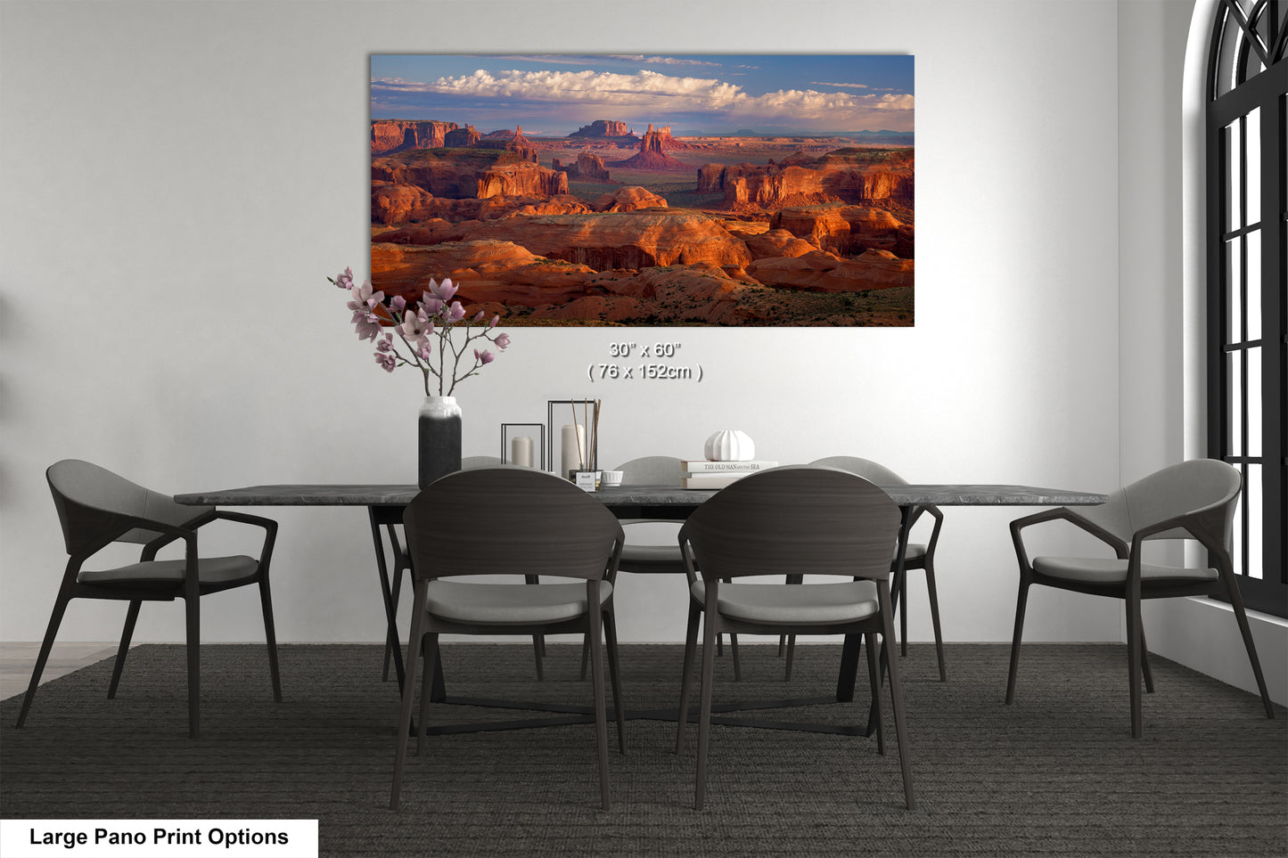 a dining room table with chairs and a painting on the wall