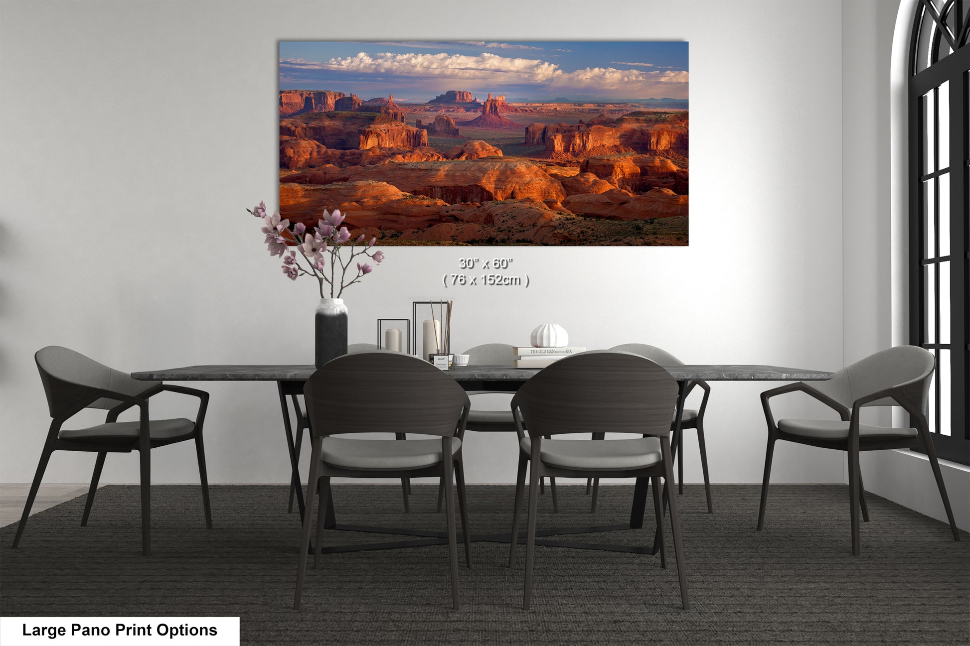 a dining room table with chairs and a painting on the wall