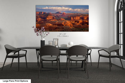 a dining room table with chairs and a painting on the wall