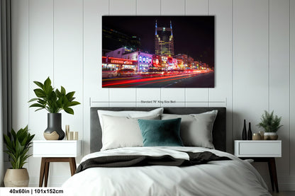 a bed in a room with a picture on the wall