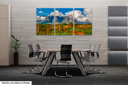 a dining room table with chairs and a painting on the wall
