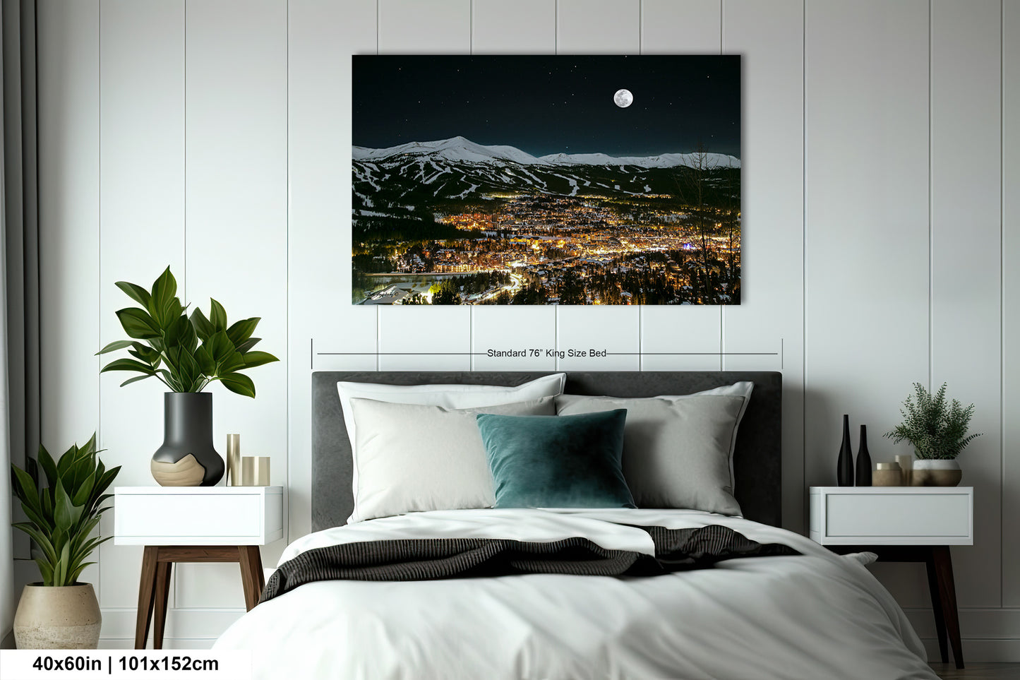 a bedroom with a bed and a night view of a city