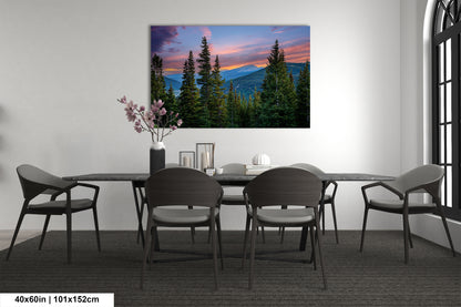 a dining room with a large painting of a mountain landscape hanging on the wall above a table with chairs.