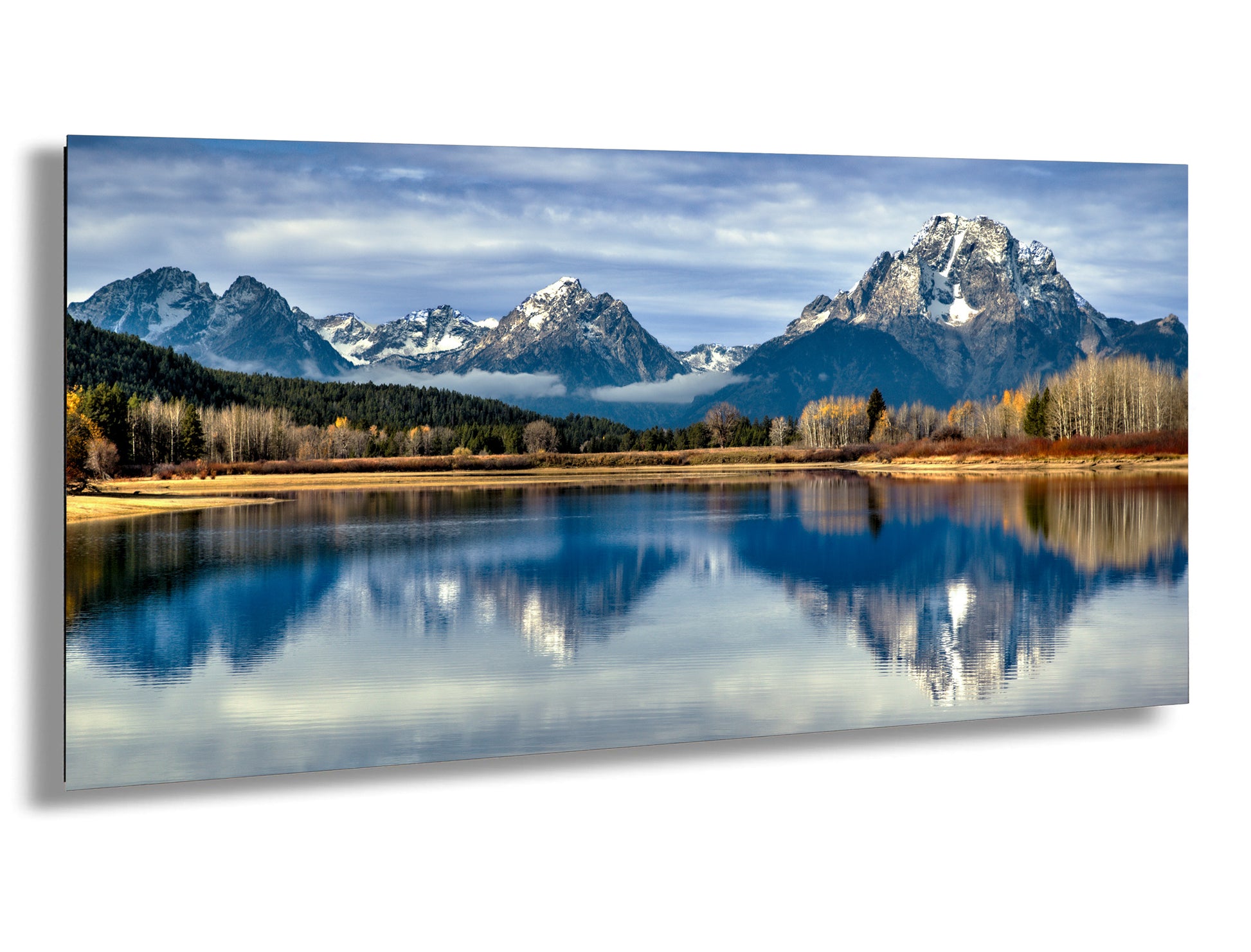 a serene landscape with a calm lake reflecting the majestic snow-capped mountains in the background.