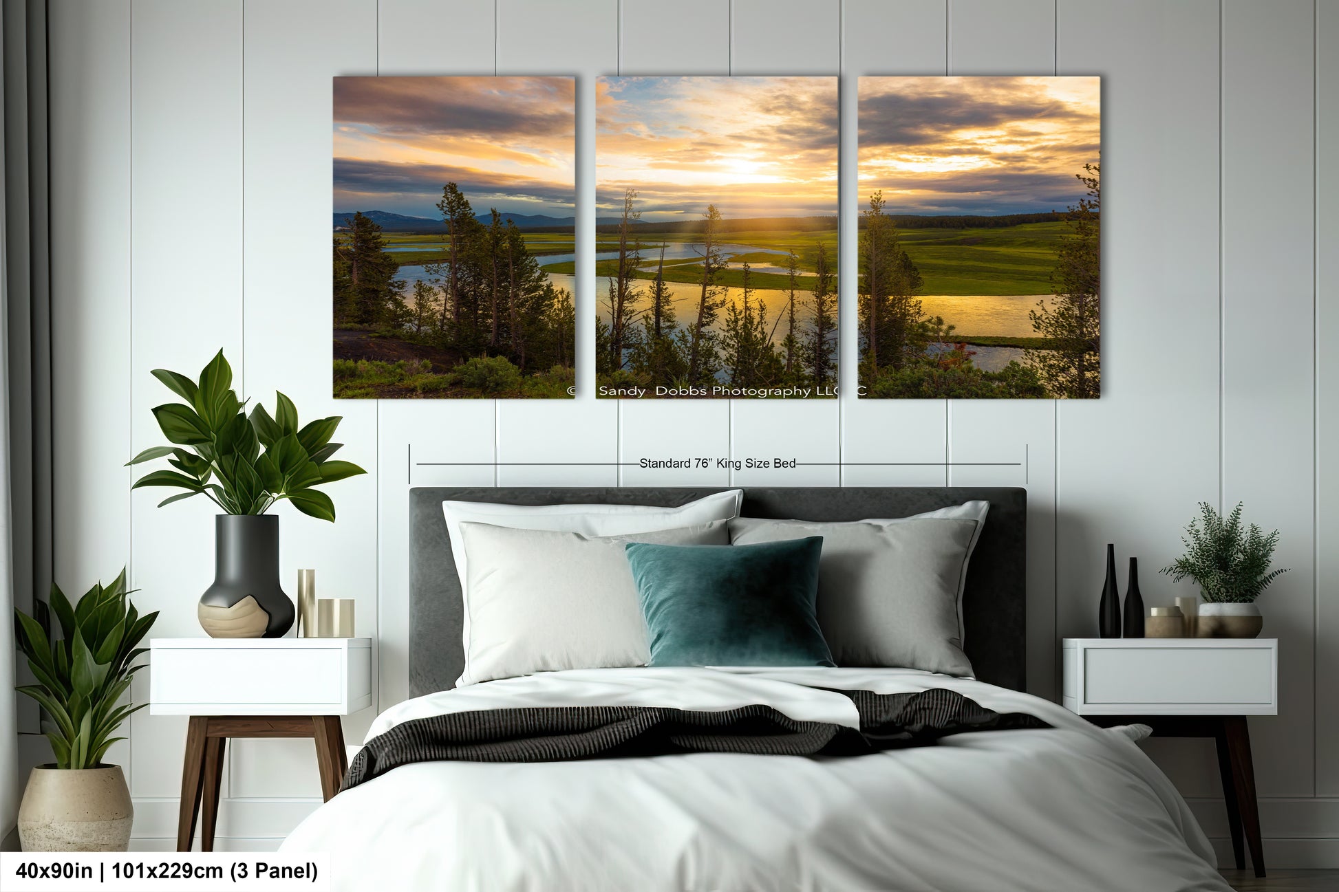 a bedroom with a bed and two paintings on the wall
