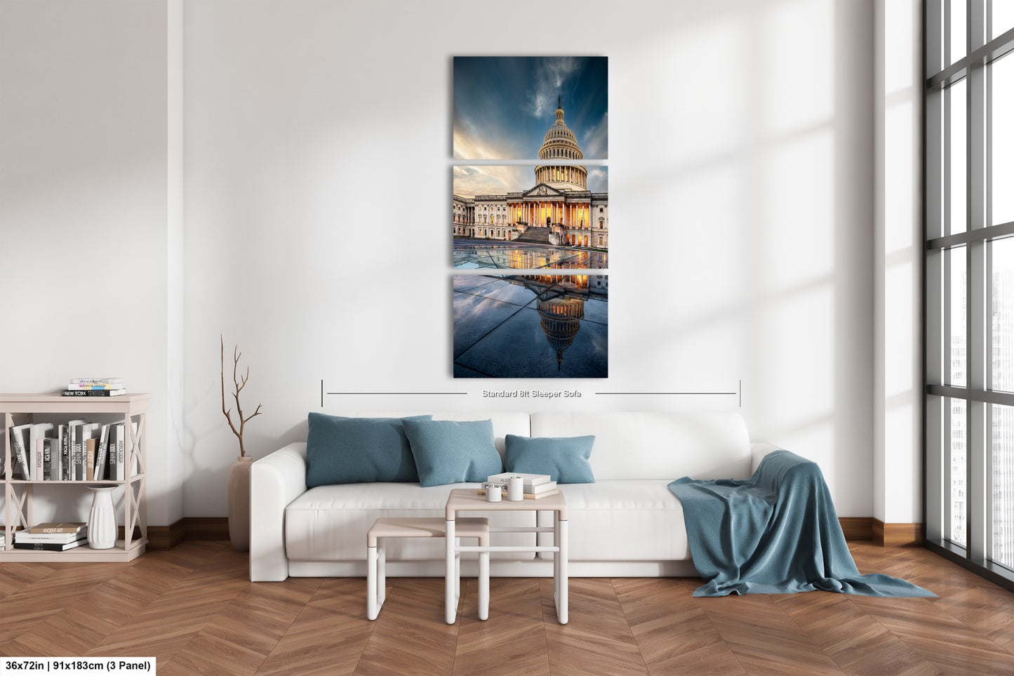 a living room with a white couch and a painting on the wall