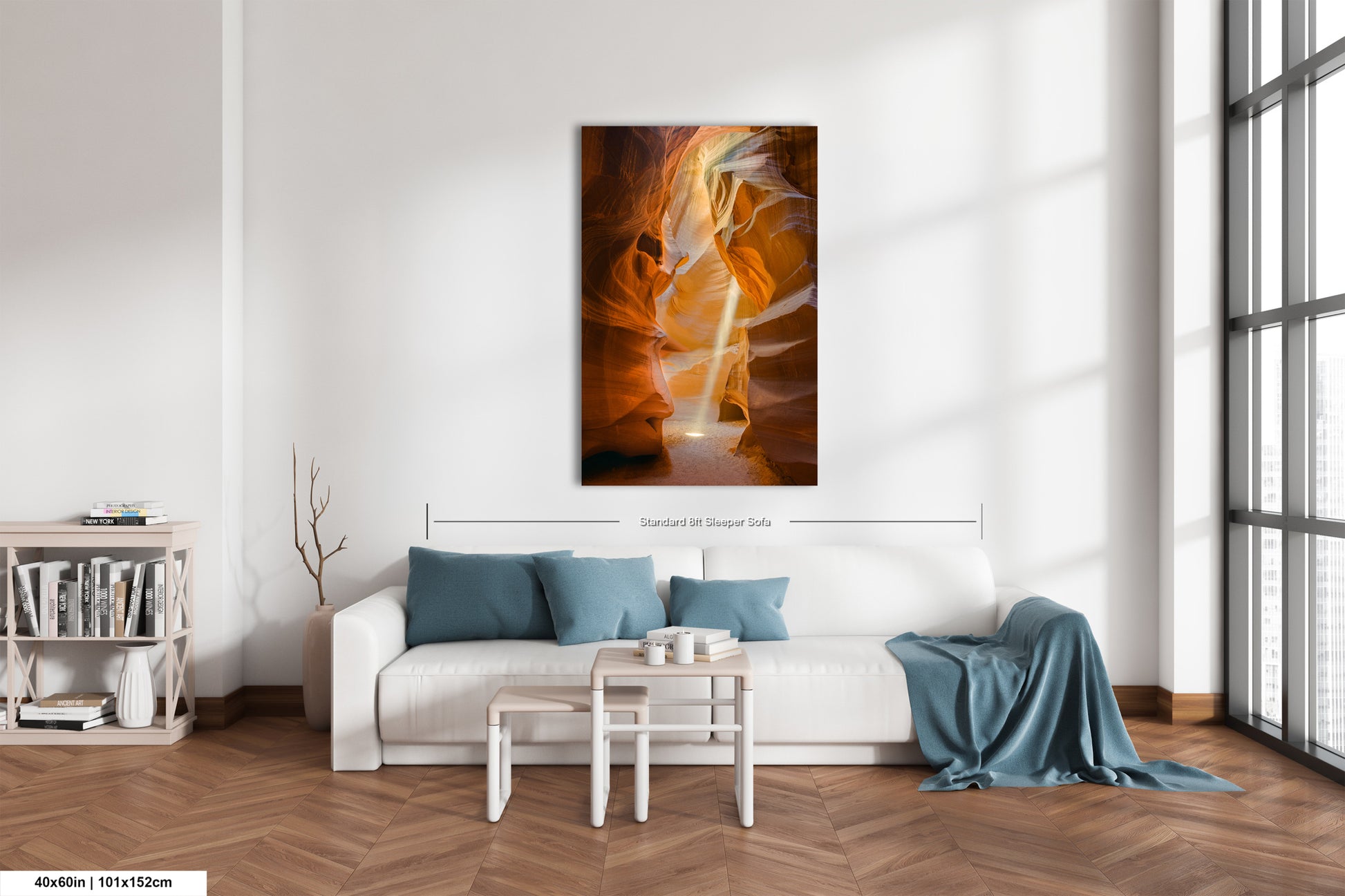 a living room with a white couch and a painting on the wall