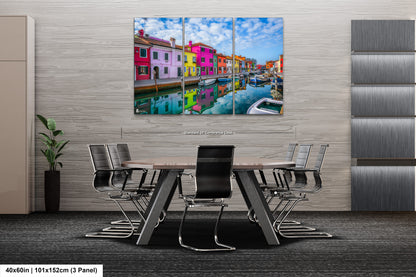 a dining room table with chairs and a painting on the wall
