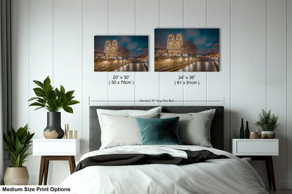 a bedroom with a bed and two pictures on the wall