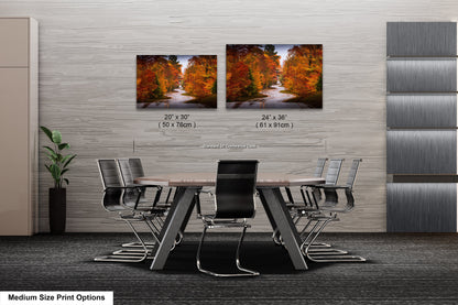 a dining room table with chairs and two pictures of trees on the wall