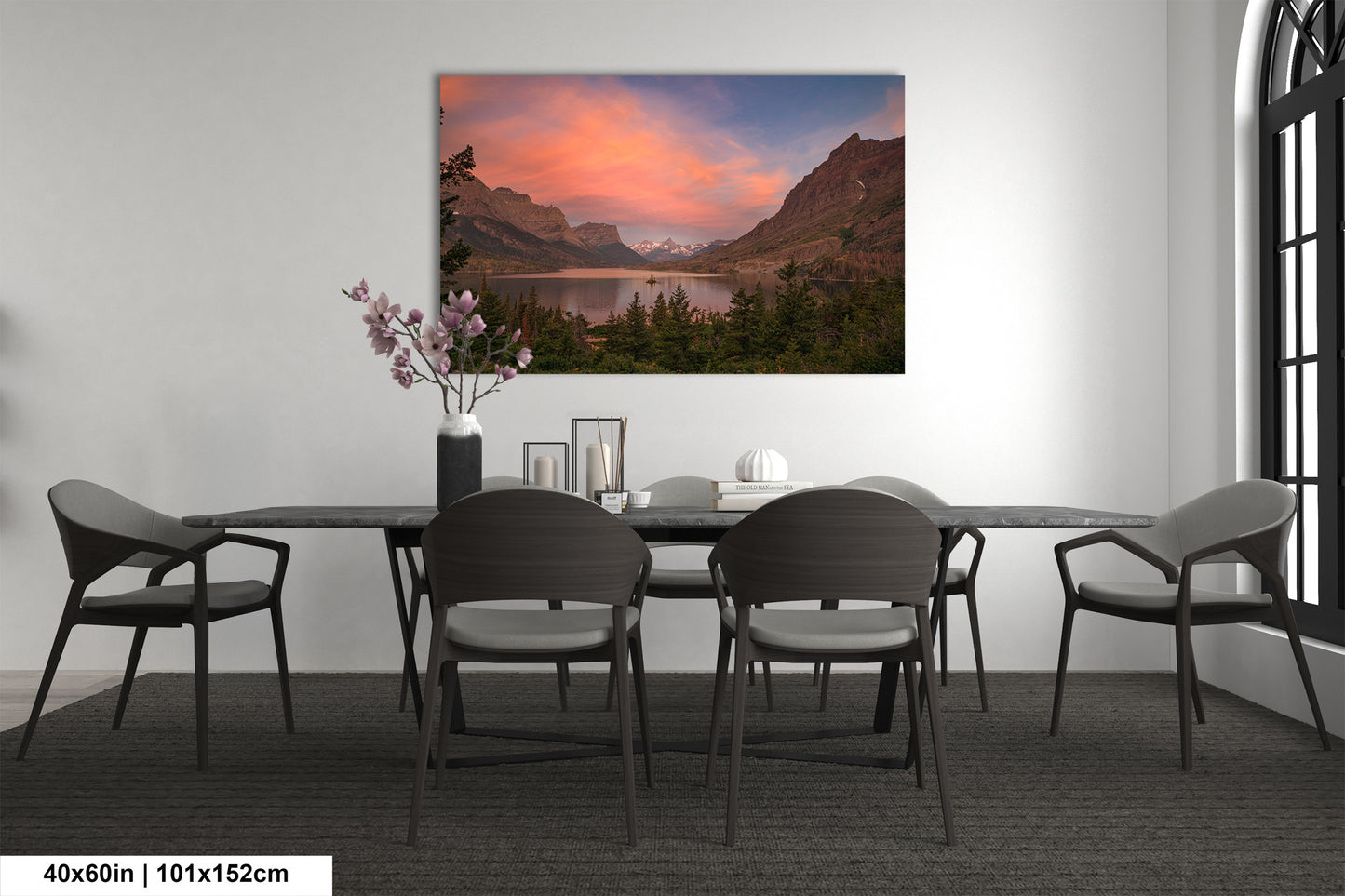 a dining room table with chairs and a painting on the wall