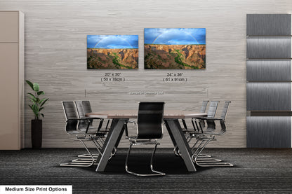 a dining room table with four chairs and two pictures on the wall