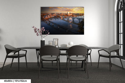 a dining room table with chairs and a painting on the wall