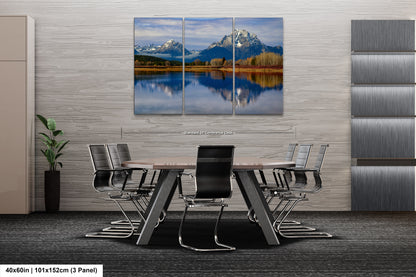 a dining room table with chairs and a painting on the wall