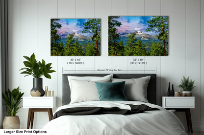 a bed with two pictures on the wall above it