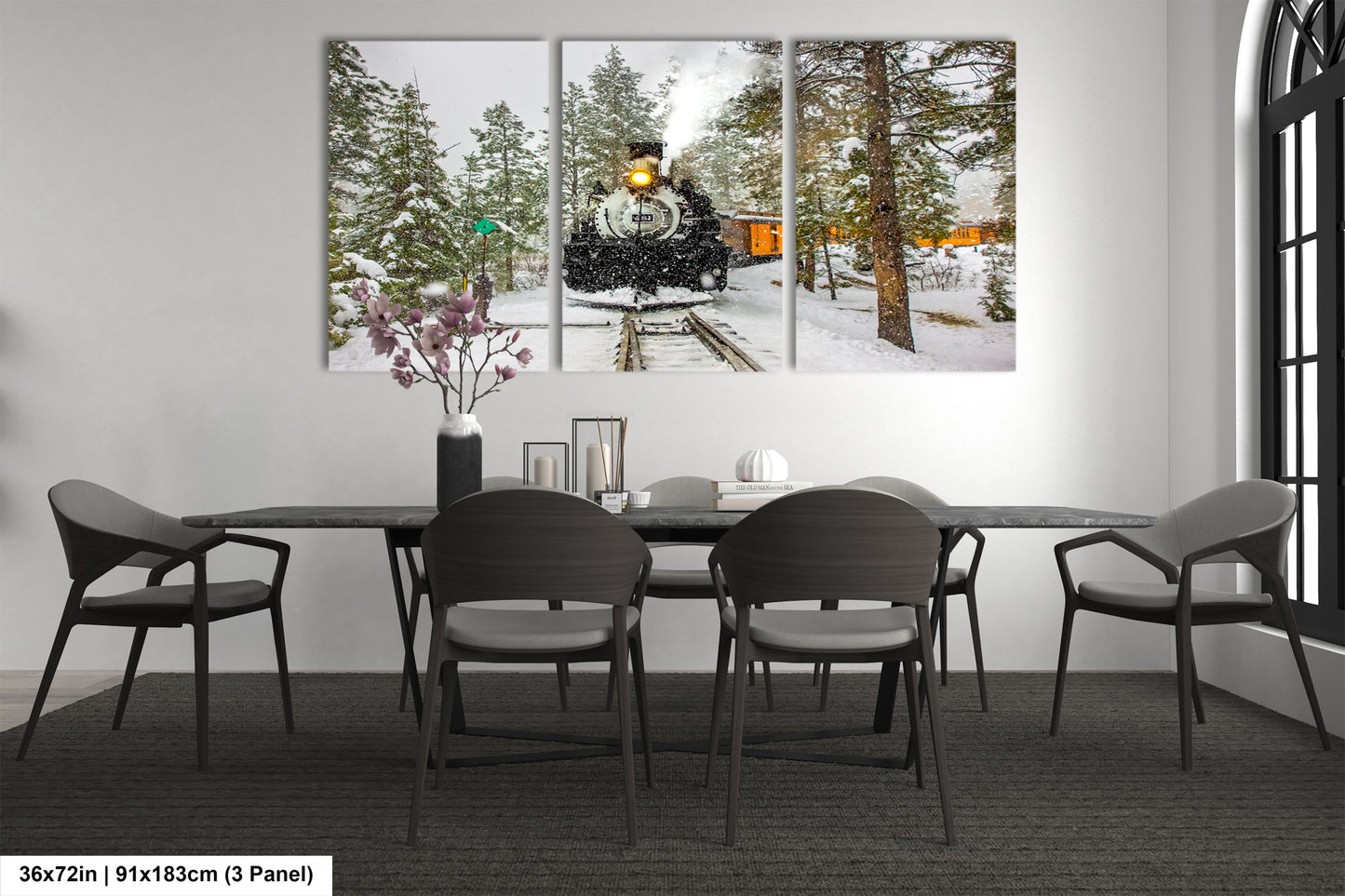a dining room table with chairs and a painting on the wall