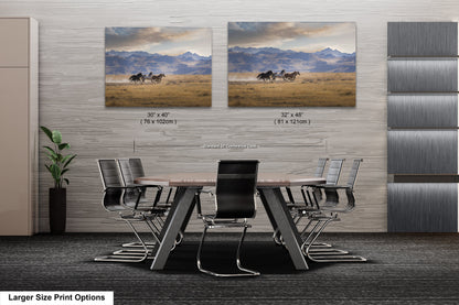 a dining room table with chairs and two pictures on the wall