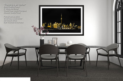 a black and white photo of a dining room table and chairs