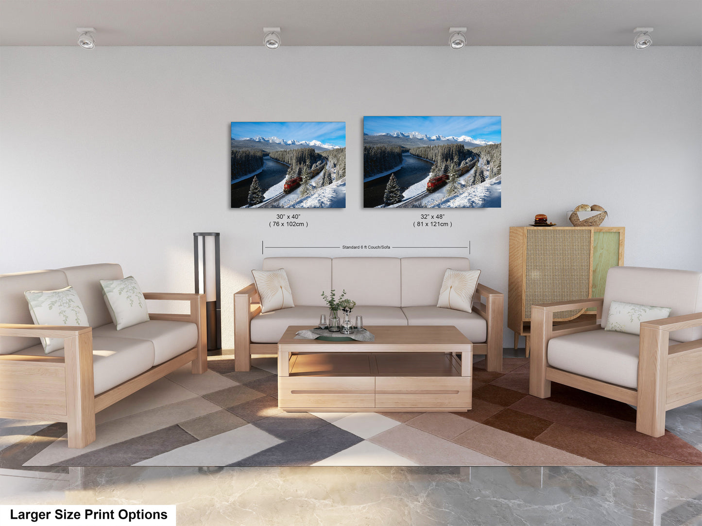 a modern living room with a large sofa, two chairs, and a coffee table. There are two framed landscape photographs hanging on the wall above the furniture.