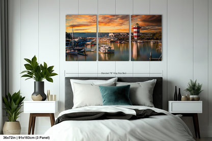a bedroom with a bed and two paintings on the wall