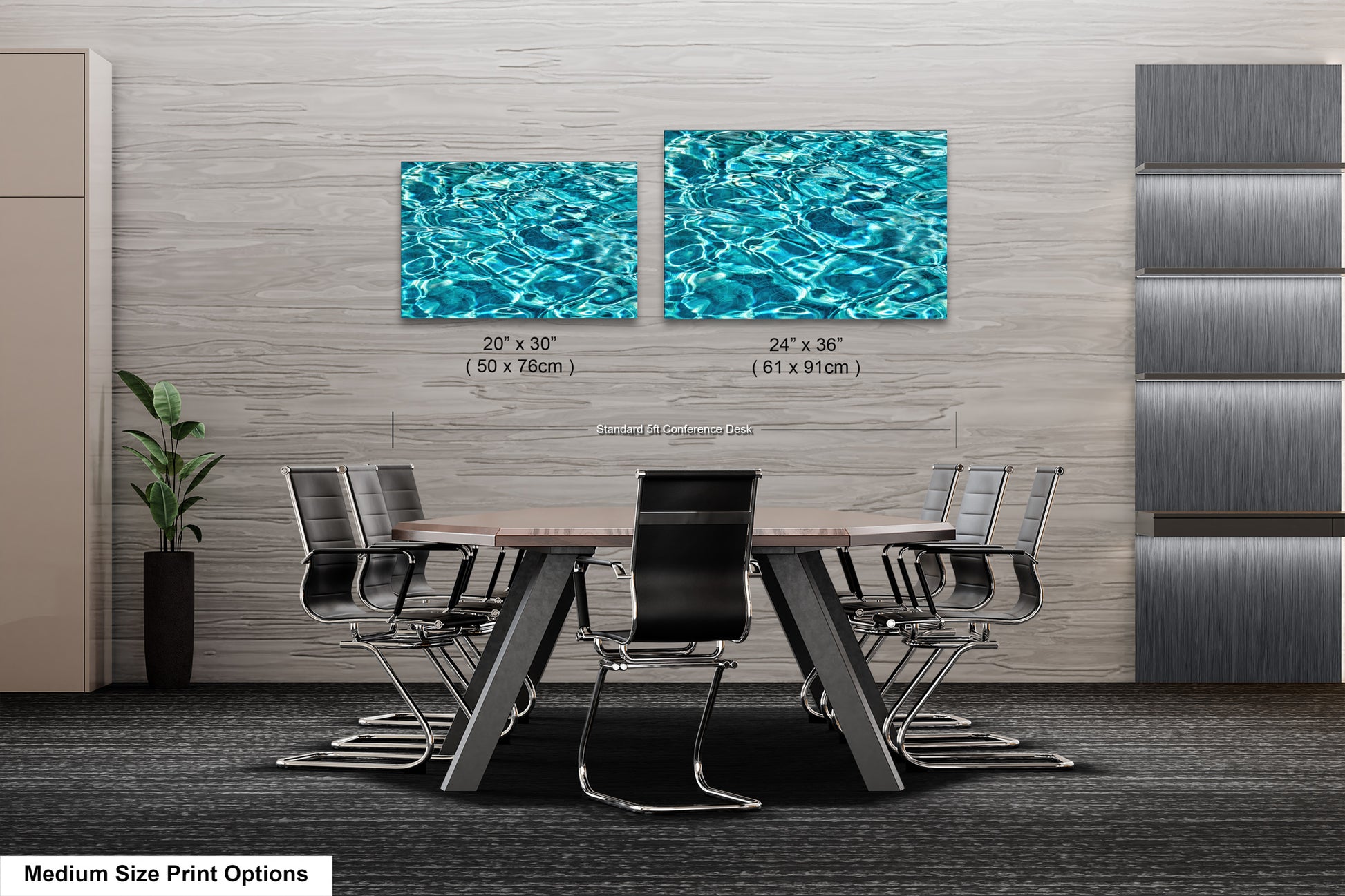 a modern office space with a large wooden table surrounded by black chairs. Two framed prints of water are displayed on the wall above the table, creating a serene and calming atmosphere.